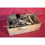 A vintage wooden box and contents of various brass