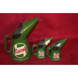 Three Castrol oil pouring cans