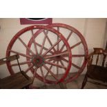 A pair of vintage cart wheels with iron rims, 127c