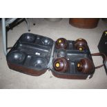 A cased set of four Lignum Vitae bowls and jack in