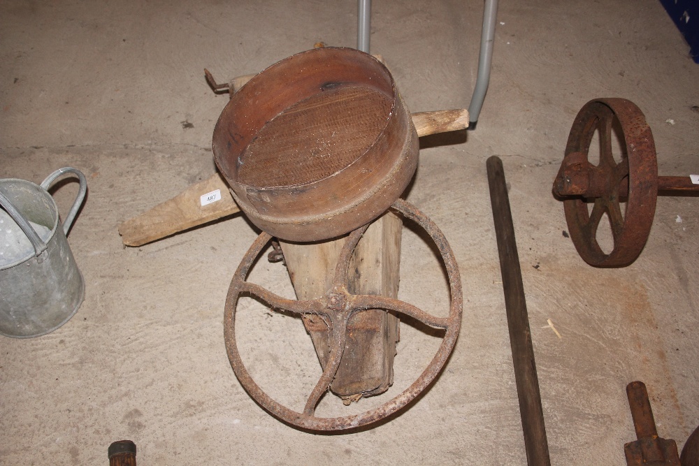 A vintage bean drill and a small sieve