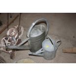 Two galvanised watering cans