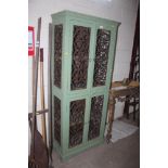 A continental painted wooden food cupboard with pierced i