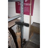 A vintage metal seed drill; a long handled drainag