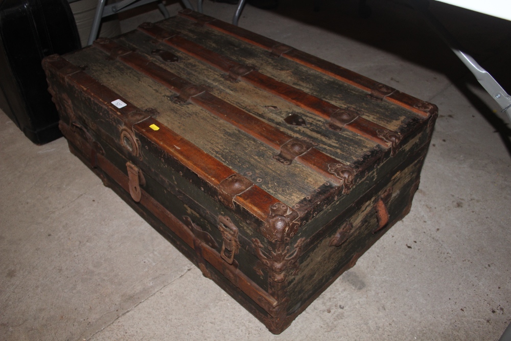 A wooden and metal bound steamer trunk