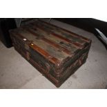 A wooden and metal bound steamer trunk