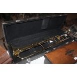 A large cased brass trombone