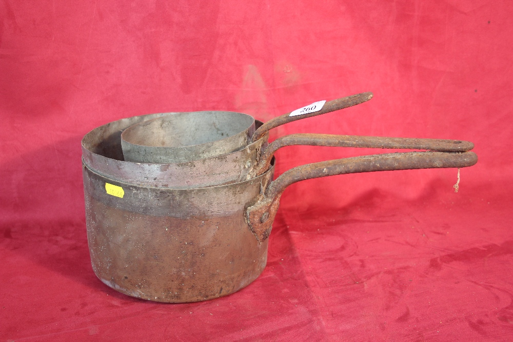 Three copper saucepans with iron handles