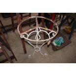 A wrought iron garden table base