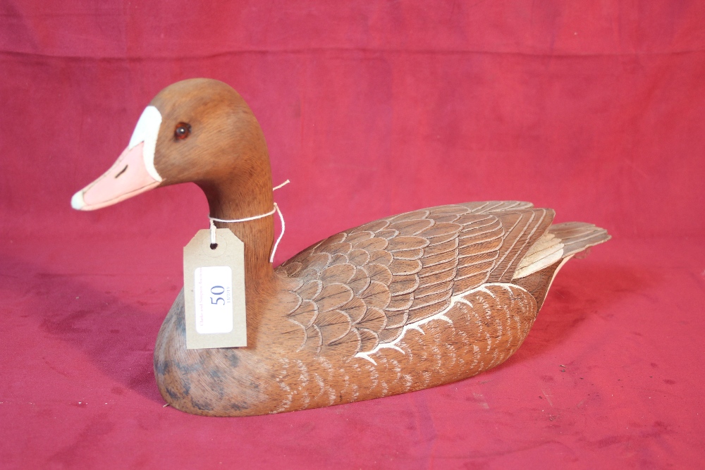 A wooden decoy model of a white front goose, by Gi