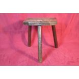 A 19th Century elm three legged milking stool