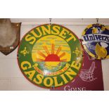 A circular enamel advertising sign for "Sunset Gaso