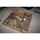 A pine tray and contents of various brass and othe