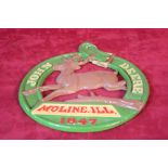 A John Deere metal plaque, 26cm diameter, belt shaped, embossed with Moline, Illinois 1847.