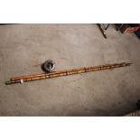 A bamboo and brass mounted fishing rod with wooden