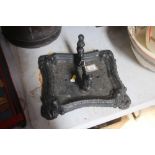 A cast iron boot scraper