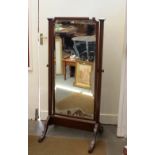 A mahogany cheval mirror, having worn bevelled plate, 151cm high x 67cm wide