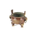 A Chinese bronze censer, having loop handles decorated calligraphy flanked by beast handles,