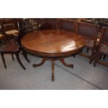 A circular mahogany tilt top supper table, raised on a turned baluster central column and