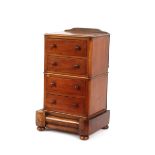 A mahogany trinket cabinet, fitted four short drawers and blind base drawer, raised on an inverted