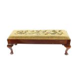 A long foot stool, raised on cabriole supports, having tapestry seat, 90cm