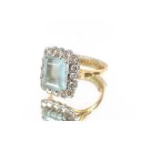 An 18ct gold diamond and 5ct aqua marine set dress ring
