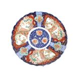 A pair of 19th Century Japanese Imari chargers, having scallop borders, panels decorated with