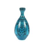 An Islamic earthenware vase, of slender baluster form, the blue ground painted with black flowers