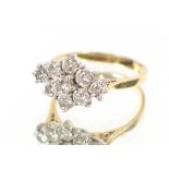 A yellow metal and diamond cluster ring