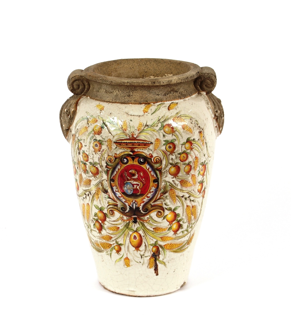 A large antique French pottery baluster vase, decorated with a central armorial surrounded by