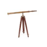 A decorative brass telescope on folding wooden tripod base