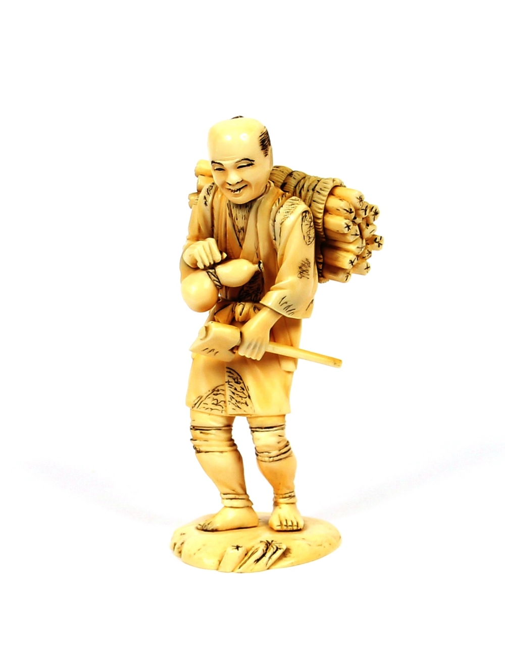 An Antique carved Japanese ivory figure of a street vendor, 14cm high