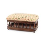 An Edwardian mahogany foot stool, raised on spindle turned supports with lifting top, 50cm wide