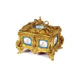 A 19th Century French ormolu trinket casket, inset with Sevres porcelain panels, the hinged lid
