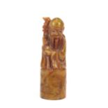 A Chinese soapstone seal, in the form of an immortal with staff, 9.5cm high