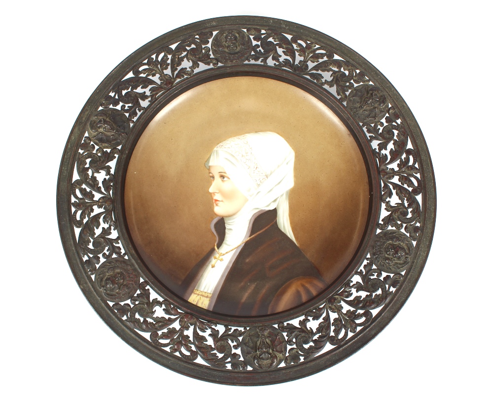 A 19th Century German porcelain plaque, decorated with portrait study of a nun, within pierced