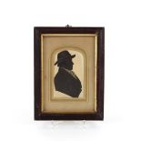 A 19th Century silhouette miniature of a gentleman with broad rimmed hat, contained in faux rosewood