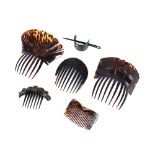 A collection of tortoiseshell hair combs, including an Art Nouveau design example with gold mount