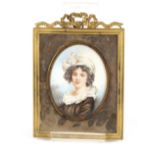 A 19th Century miniature portrait study, of a young girl wearing mop cap, in gilt easel frame with