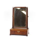 A George III mahogany swing toilet mirror, raised on single drawer box base with ogee bracket