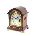 A walnut cased chiming mantel clock, by Garrard, raised on gilt bracket supports, 29cm high