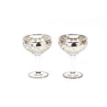A pair of good quality cut glass and silvered overlay champagne saucers; and a pair of hobnail cut