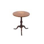 A 19th Century oak circular snap top tea table, raised on baluster central column and tripod base,
