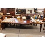 A Victorian mahogany extending dining table, fitted three extra leaves, raised on turned baluster