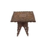 A small ornately carved Eastern hardwood occasional table, decorated with dragon and foliage, 37cm
