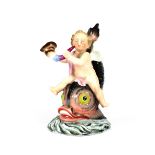 A small late 19th Century German porcelain figure, depicting a cherub riding on a stylised dolphin's