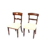 A set of three early 19th Century mahogany bar back dining chairs; and another similar, (4)