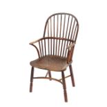 A 19th Century elm and yew wood stick back Windsor chair, the shaped seat raised on turned