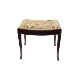 A mahogany piano stool, having needlepoint seat, raised on square tapering outswept supports, 54cm