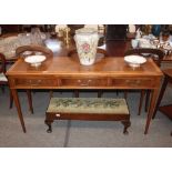 A walnut hall table, fitted three drawers, raised on square section tapering supports, 145cm wide